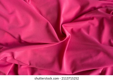 Soft Focus Texture Of The Silk Fabric. Hot Pink Fabric Background.  Crumpled Magenta Color Satin Texture . Fuschia Textile Background.