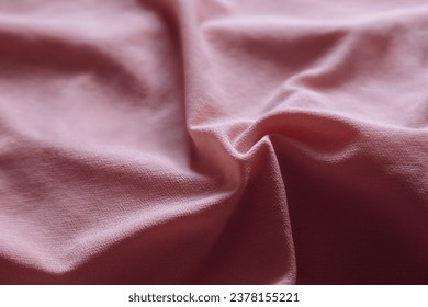 Soft focus texture of the silk fabric, pastel pink. Faded peach pink fabric background.  Crumpled soft rose color satin texture Powder textile background.