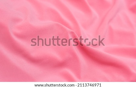 Soft focus texture of the silk fabric, soft pink. Peach pink fabric background.  Crumpled soft rose color satin texture   Pastel textile background.