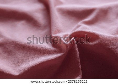 Soft focus texture of the silk fabric, pastel pink. Faded peach pink fabric background.  Crumpled soft rose color satin texture Powder textile background.