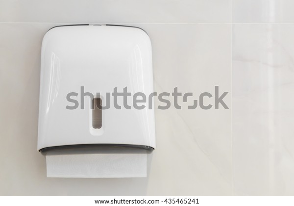 Soft focus tissues paper towel dispenser on\
granite wall in barthroom