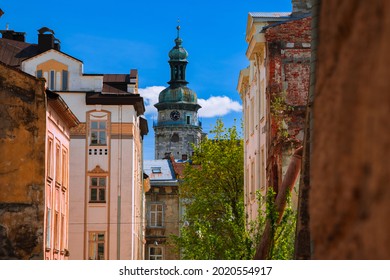 Soft Focus Travel Destination Photography Of Back Street View On Catholic Cathedral Tower Spire Between Old Building In Eastern Europe 