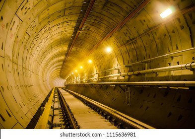 Soft focus of Underground tunnel construction.Transport pipeline by Tunnel Boring Machine for electric train subway with lighting.
