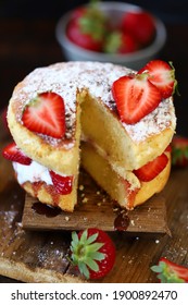 Soft focus. Victoria sponge cake. The famous dessert biscuit with strawberries.