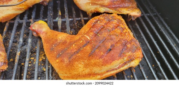 Soft Focus View Of Chicken Legs And Thighs Seasoned Up On Pellet Smoker Barbecue Grill Golden Brown