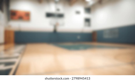A soft focus view of an empty indoor basketball court showing the wooden floor and hoop