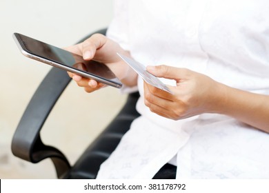 soft focus woman asian using phone and credit card shopping online , selective focus on hand