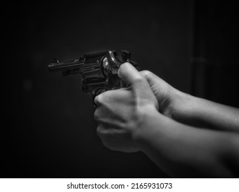 Soft Of Focus. Woman Pointing Gun At Target On Dark Background, Front Gun Focus, Vintage Tone