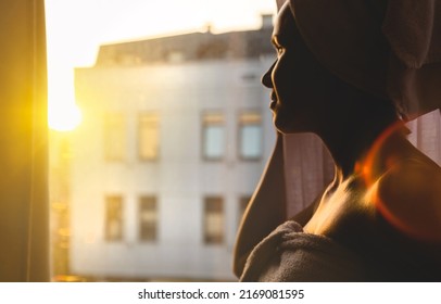 Soft Focus Woman Wrapped Bath Towels Standing Near The Window And Looking At Sunrise.