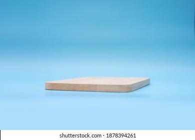 Soft Focus Of Wooden Base On Blue Background.