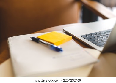 Soft Focus Yellow Stick Note Paper With Laptop Computer On Wooden Table. No People Background.