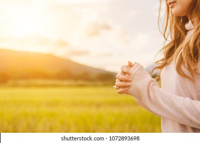 Soft Focus,A young woman praying for God's blessings with the power and power of the sacred On the background of sunrise in the morning over a golden meadow.
The concept of God and spirituality.
