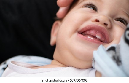 Soft Focused Baby Facial Expression, Infant Is Very Happy, Has. Big Smile Shows His Teething Gum