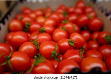 Soft focused shot of vegetable department in grocery store, supermarket, mall, hypermarket or shopping center. Boxes with red tomatoes. Vegetarian healthy food concept.