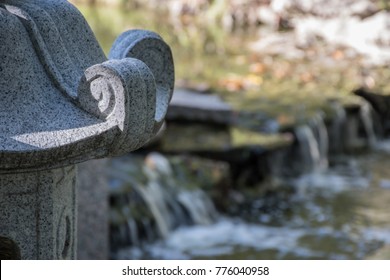 Soft Focused Water Flows Behind Garden Carving At Fort Worth Japanese Garden