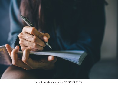soft focus.hand high school or university student in casual holding pencil writing on paper answer sheet.sitting on lecture chair taking final exam or study attending in examination room or classroom - Shutterstock ID 1106397422