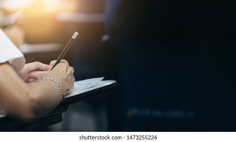 soft focus.high school student study.hands holding pencil writing paper answer sheet.sitting lecture chair taking final exam attending in examination classroom.concept scholarship for education abroad - Shutterstock ID 1473255224