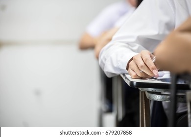 Soft Focus.university Or High School Student Holding Pencil.sitting On Row Chair Writing Final Exam In Examination Room Or Study In Classroom.student In Uniform.education Concept