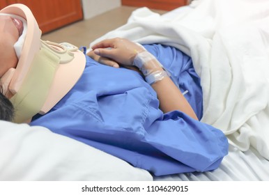 Soft focus,Woman after surgery patient sleeps on a bed in hospital.putting cervical collar on neck. - Powered by Shutterstock