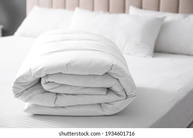 Soft folded blanket on bed at home