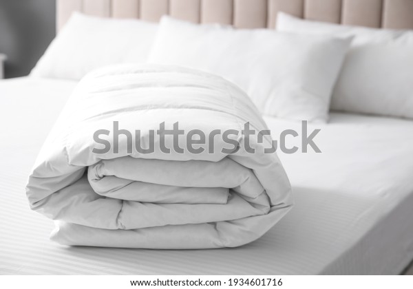 Soft folded blanket on bed\
at home