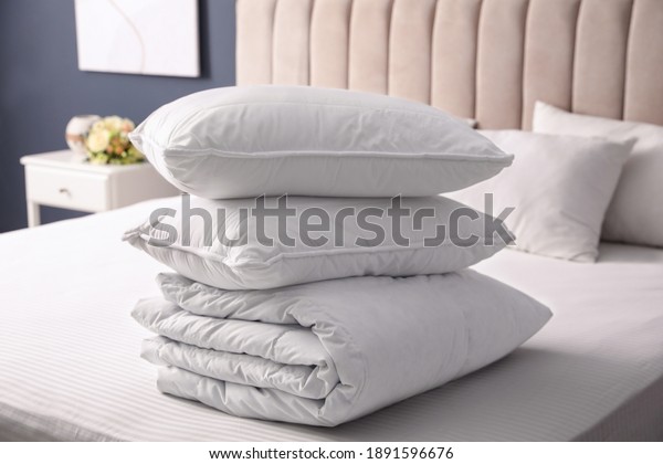 Soft folded
blanket and pillows on bed
indoors