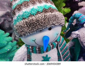 Soft Funny Cheerful Smiling Snowman In Winter Hat With Blue Nose. Crafters Virtual Christmas Fair. Cute Handmade Gift Toy. Happy New Year. Xmas Collection. Sewing Doll For Kids. Traditional Festival.
