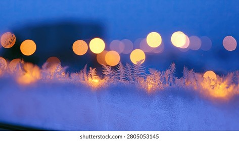 Soft, glowing bokeh lights create a dreamy, abstract effect against a cool blue, frosted backdrop.