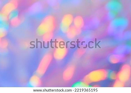 Soft gradient background with Smooth Blurred holographic iridescent colors with golden bokeh. Festive glittering background.