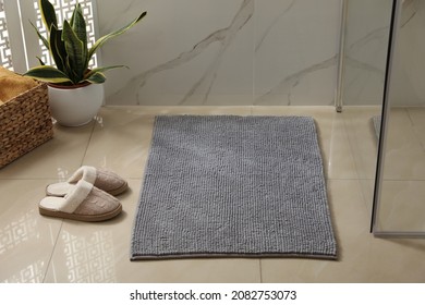 Soft Grey Bath Mat And Slippers On Floor Indoors