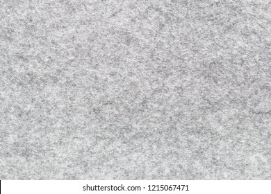 Soft grey felt material. Surface of felted fabric texture abstract background in gray color. High resolution photo.