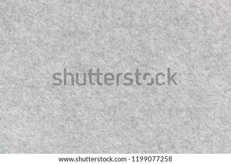 Soft grey felt material. Surface of felted fabric texture and abstract background. High resolution photo.