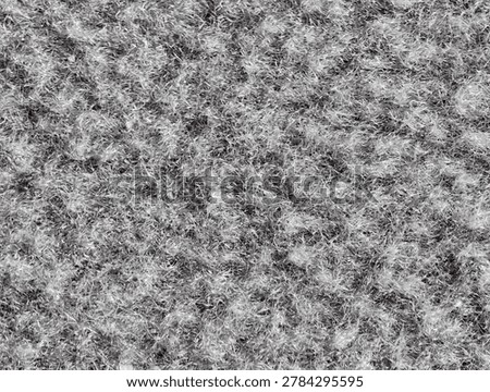 Soft grey wool texture closeup, dense felted fibers creating warm tactile surface, subtle mottled tones