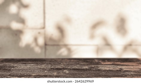 Soft leaf shadows fall on a tiled wall behind a rustic wooden table, evoking a calm, sunlit atmosphere perfect for quiet moments or natural product displays