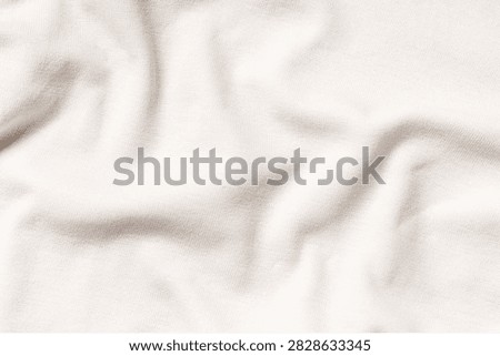 Soft light beige fabric texture with subtle wrinkles with showcasing gentle folds natural wrinkles under diffused lighting serene minimalist aesthetic finely textured fabric soft beige tone