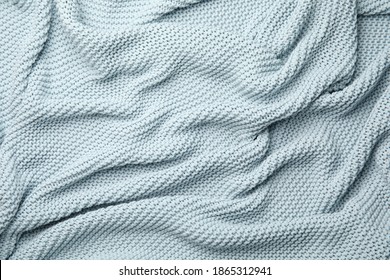 Soft Light Blue Knitted Plaid As Background, Top View