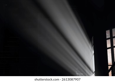 Soft light illuminates a dark interior space.