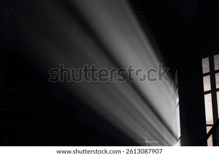 Soft light illuminates a dark interior space.