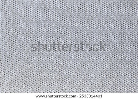 Soft light natural texture of knitted wool textile material background. White crochet cotton fabric woven canvas texture close up