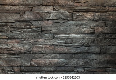 Soft light on pieces of Stone cladding wall. made of striped stacked slabs of natural brown rocks for walls texture and background, Copy space,