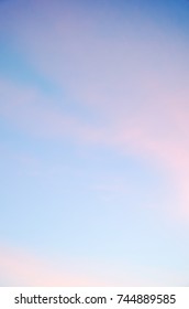Soft light pink clouds at blue sky. Soft and fluffy light pink clouds at background blue sky in October morning.