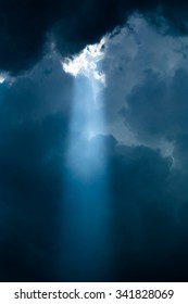 Soft Light Rays Of Light Shining Down Ground. Dark Sky With Sun Rays