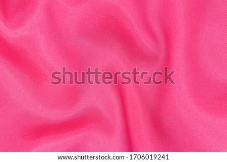 Soft, luxurious dark pink or satin fabric. It can be used as a glamorous wedding texture or background for a lovers ' holiday.