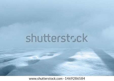 Soft Minimalist Landscape of Snow Field with Snowmobile Tracks and Cloudy Sky