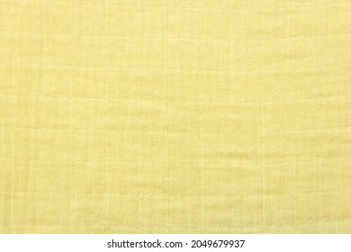 Soft Muslin Baby Blanket Background. Cotton Clothing And Textiles. Natural Organic Fabrics Texture. Light Yellow, , Lemon Color. Close Up