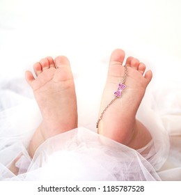 Soft Newborn Baby Feet And White Gold Bracelet