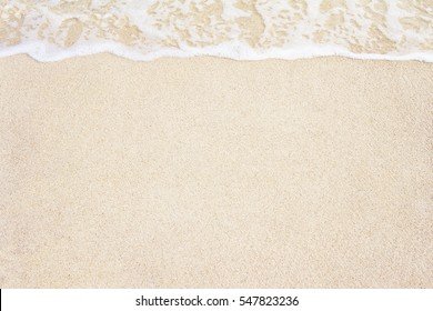 Soft Ocean Wave On Sandy Beach Background.