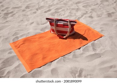 Soft Orange Beach Towel And Bag On Sand