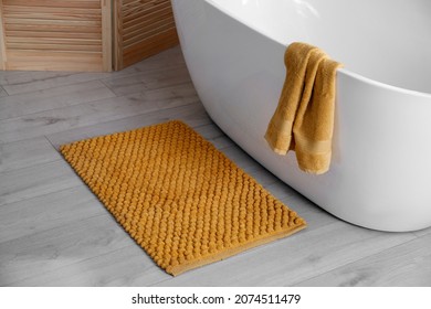 Soft Orange Mat On Floor Near Tub In Bathroom. Interior Design