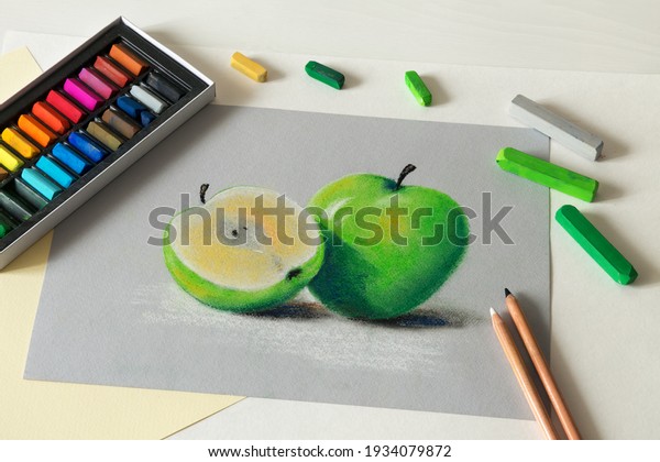 Soft pastel drawing, painting on paper.\
Picture of apple. Set of soft pastel chalks.\
